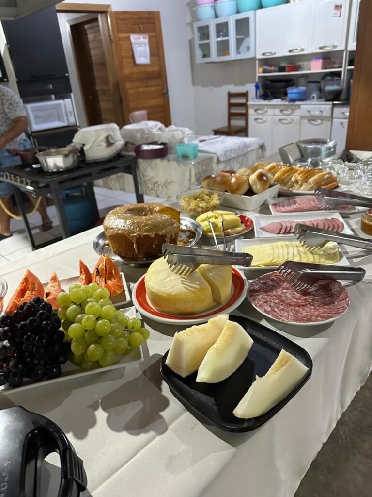 Breakfast table with fruit, cheese, cold cuts and cakes