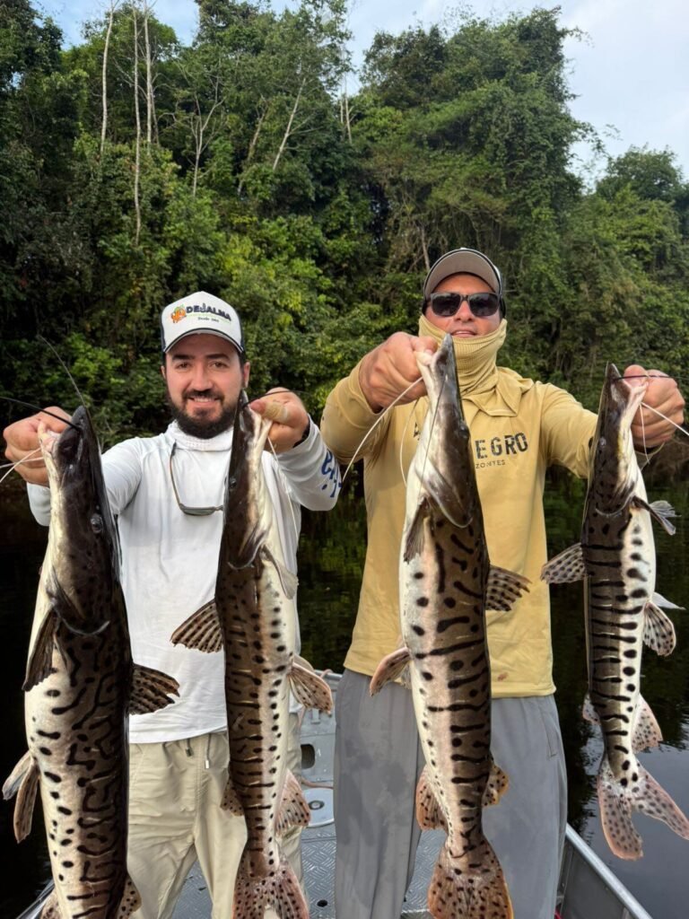Guest holding a fish caught in the river