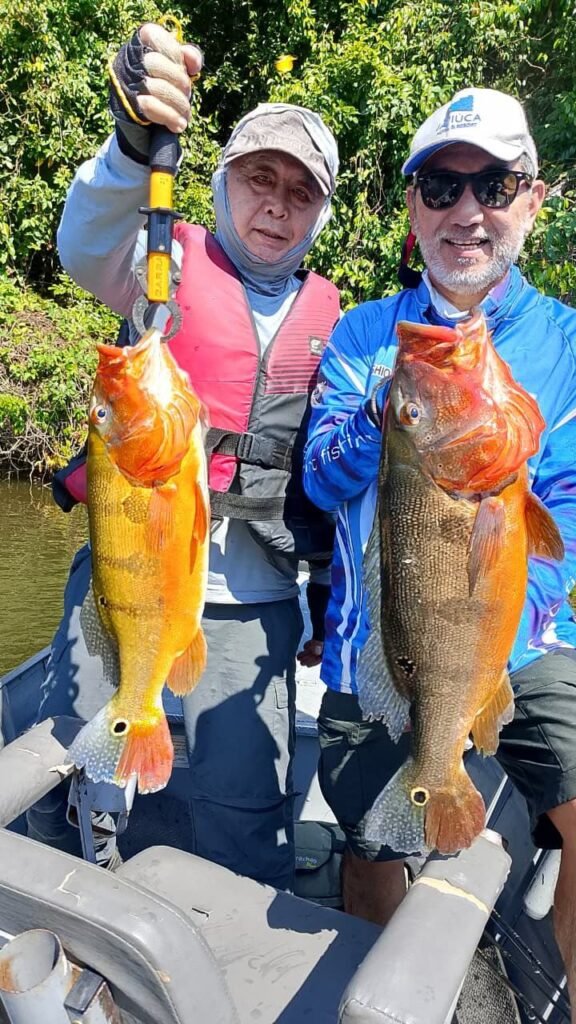 Guest holding a fish caught in the river