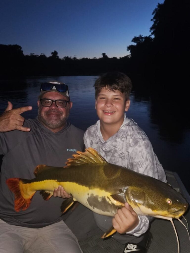 Guest holding a fish caught in the river