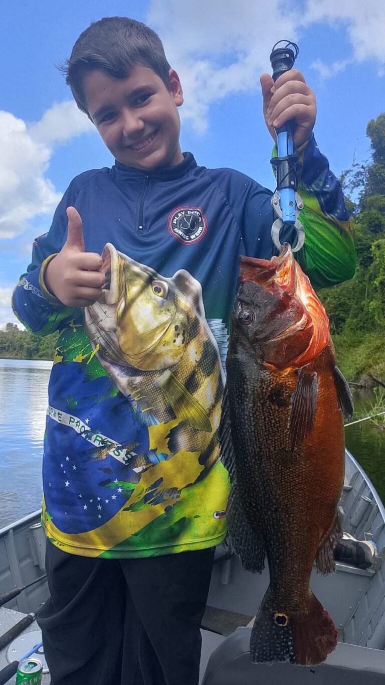 Guest holding a fish caught in the river