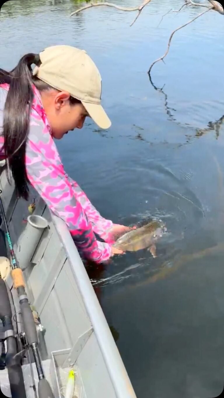 Guest holding a fish caught in the river