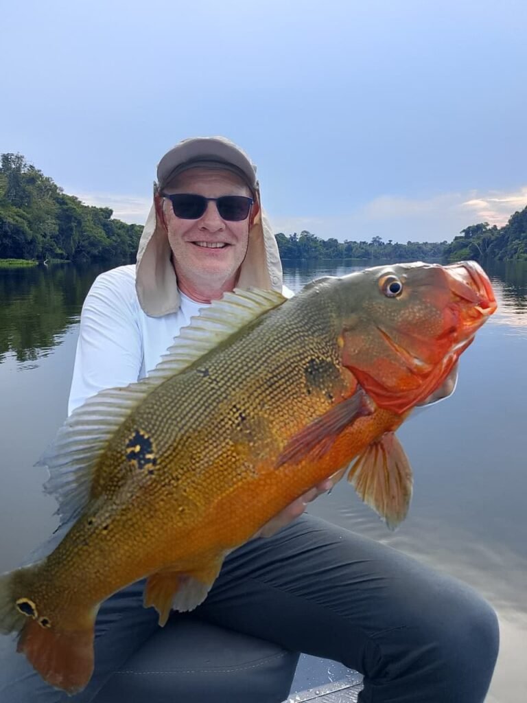 Guest holding a fish caught in the river