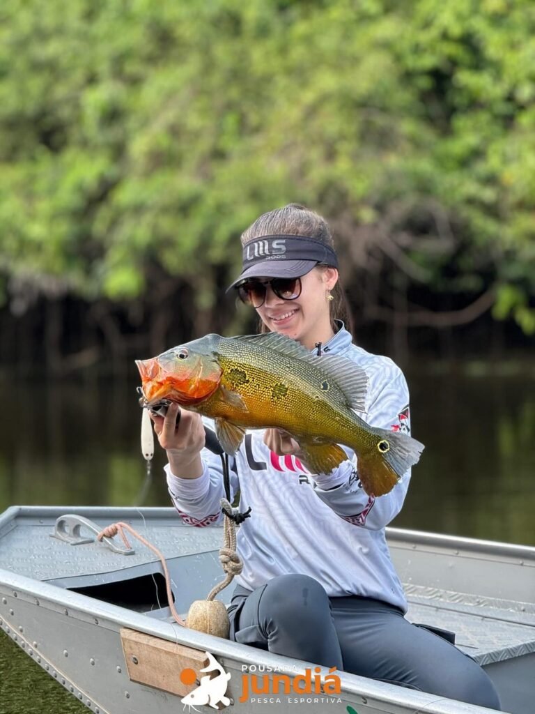 Guest holding a fish caught in the river