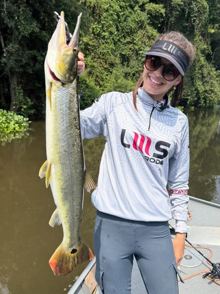 Guest holding a fish caught in the river