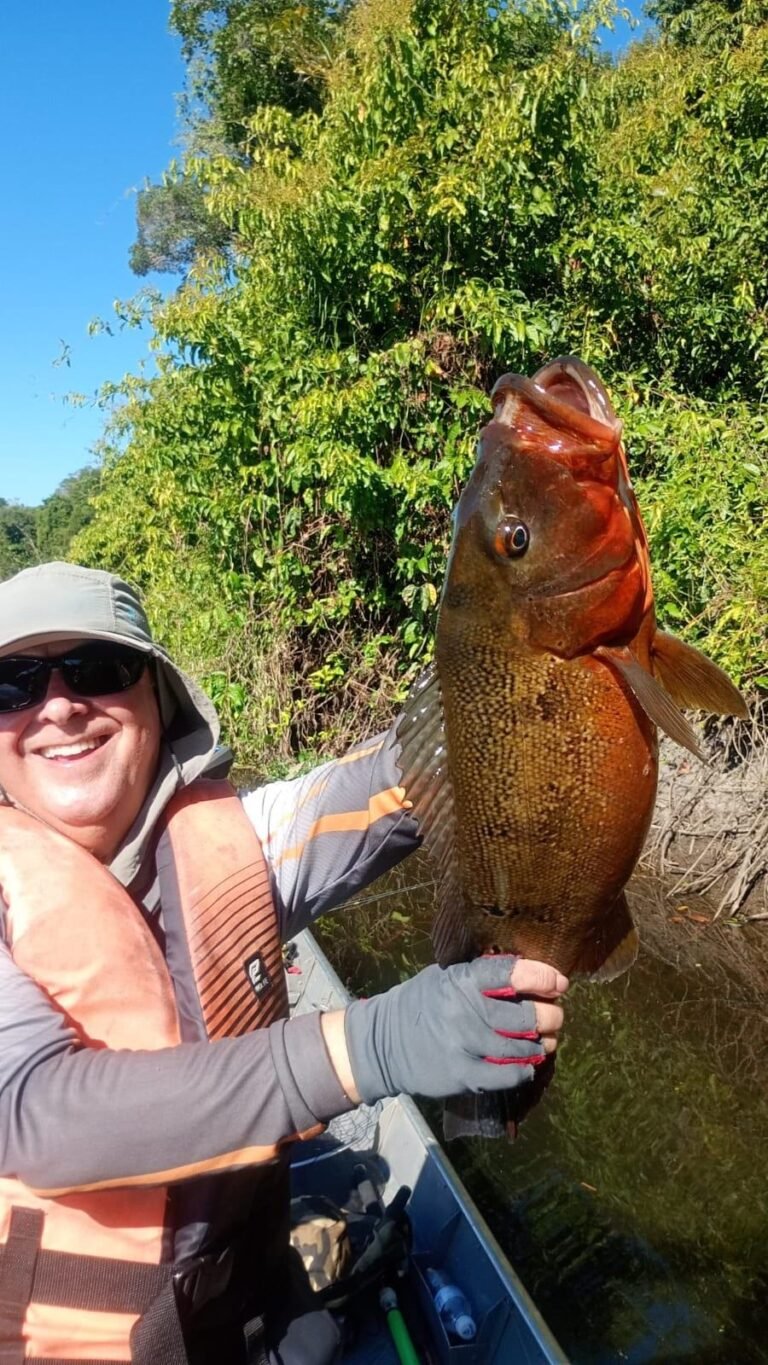 Guest holding a fish caught in the river