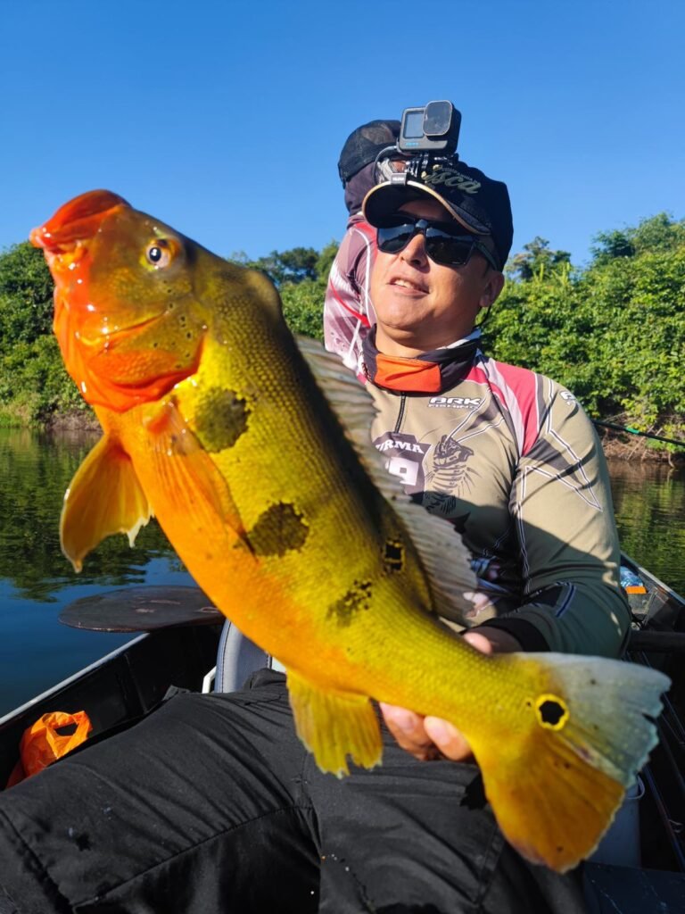 Guest holding a fish caught in the river