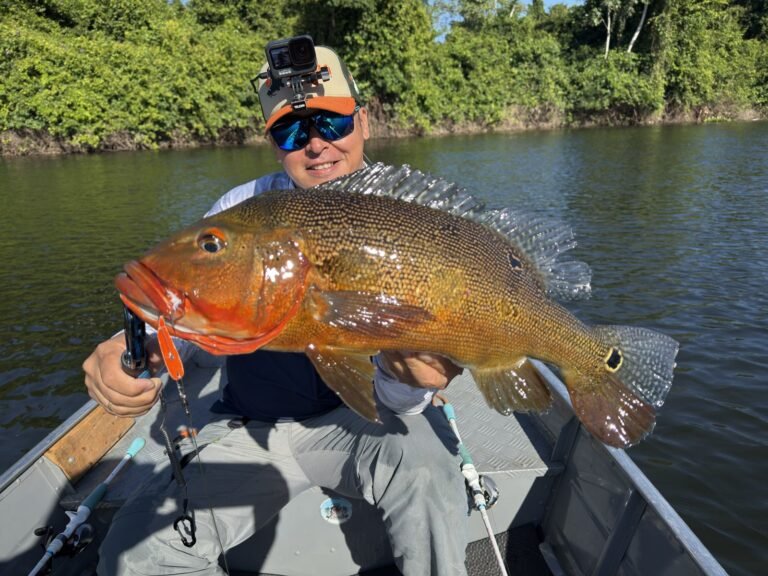 Guest holding a fish caught in the river