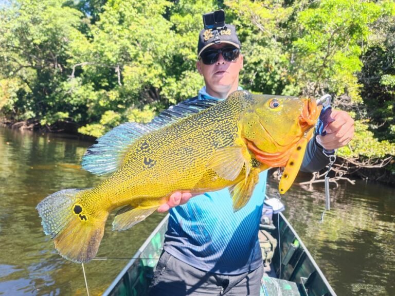 Guest holding a fish caught in the river