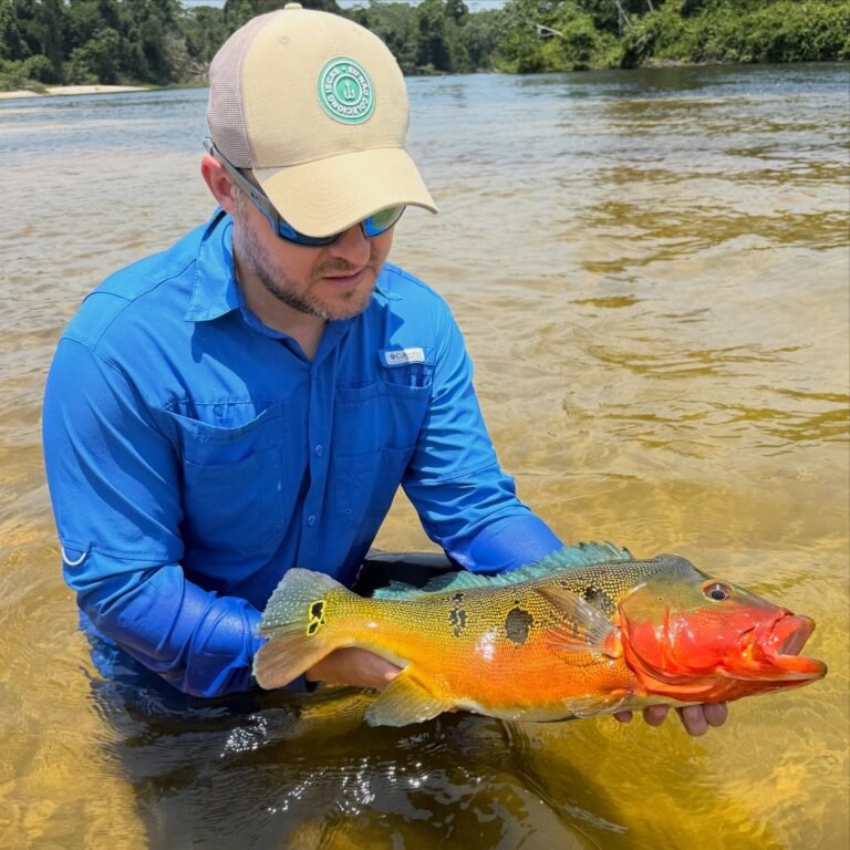 Guest holding a fish caught in the river