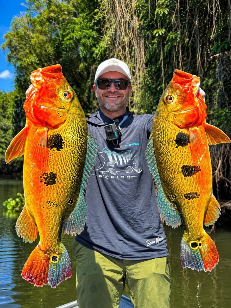 Guest holding a fish caught in the river