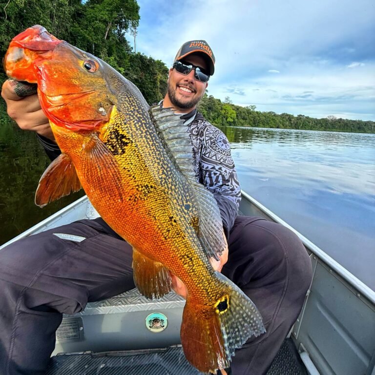 Guest holding a fish caught in the river