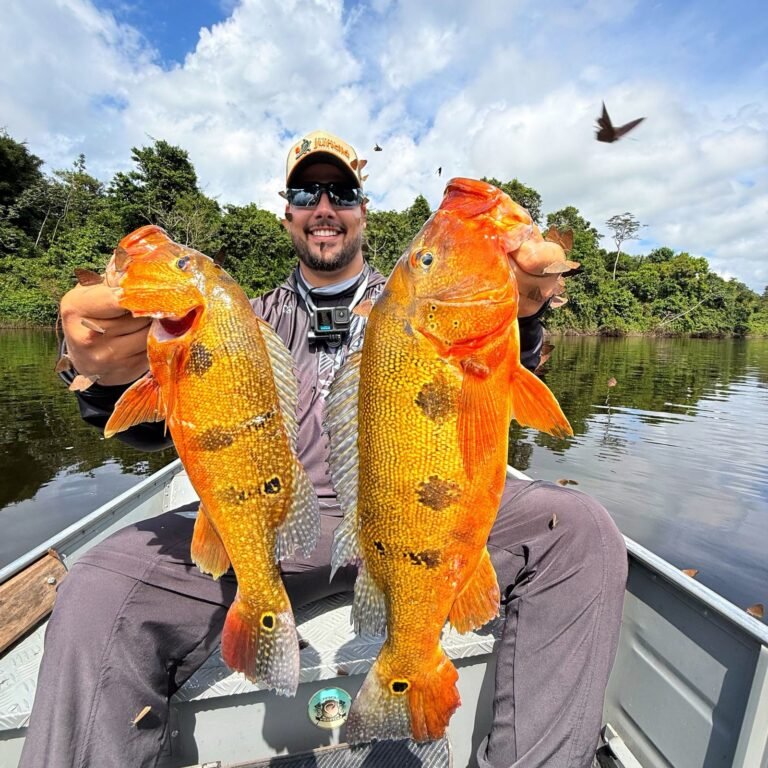 Guest holding a fish caught in the river