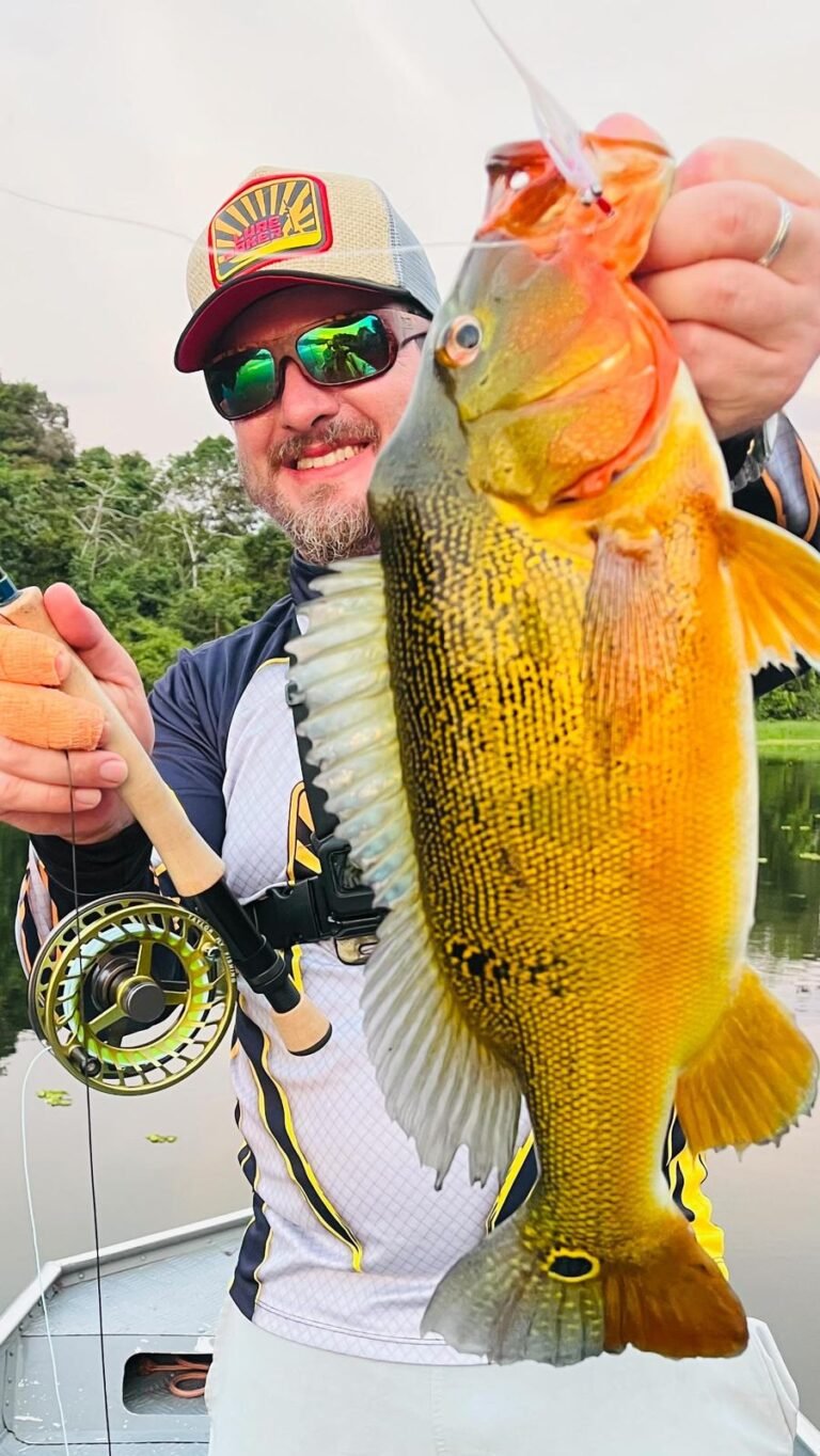 Guest holding a fish caught in the river