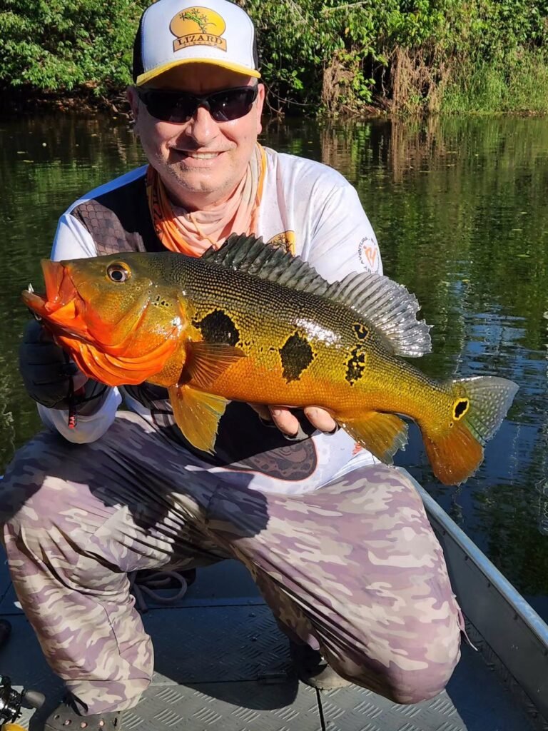 Guest holding a fish caught in the river