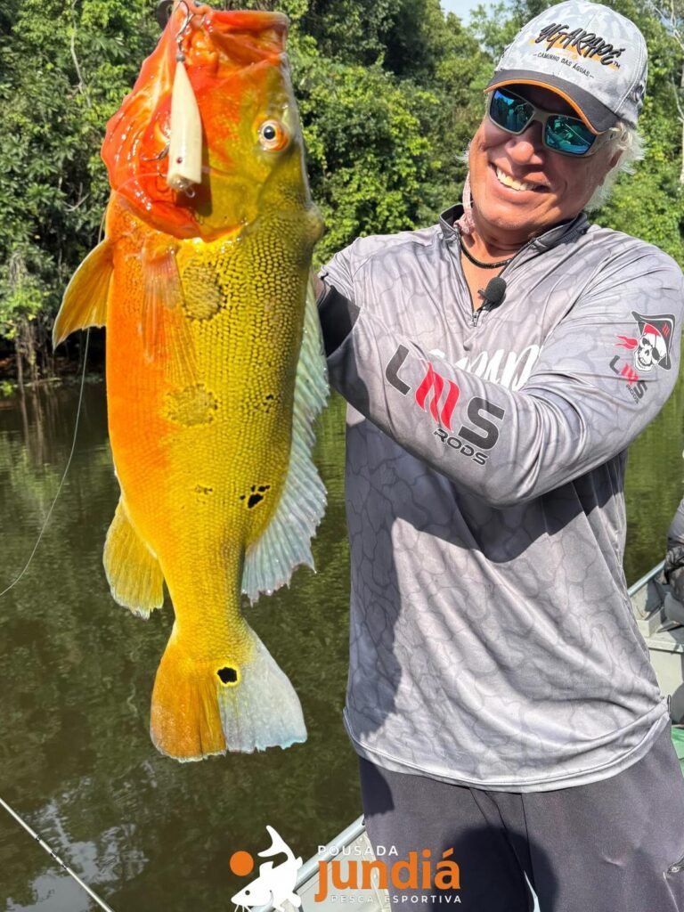 Guest holding a fish caught in the river