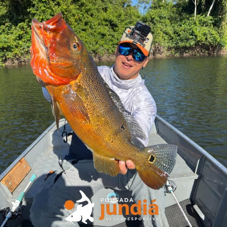 Guest holding a fish caught in the river