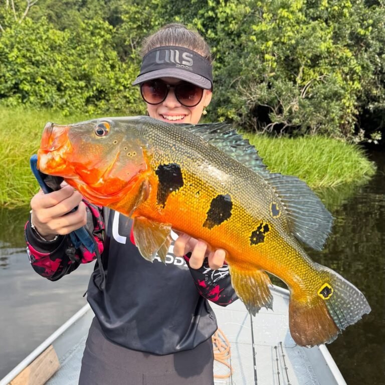 Guest holding a fish caught in the river