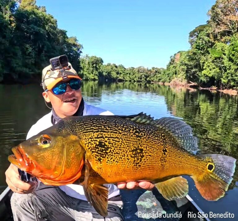 Guest holding a fish caught in the river