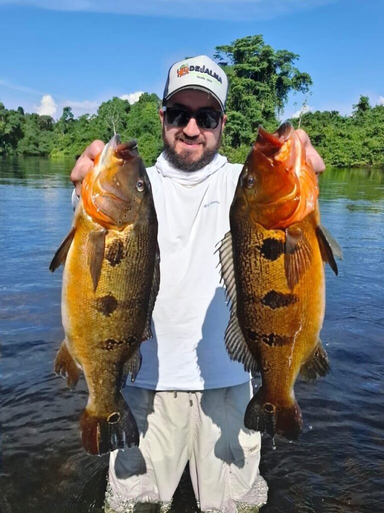 Guest holding a fish caught in the river
