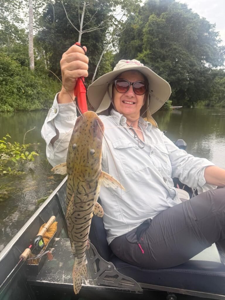 Guest holding a fish caught in the river