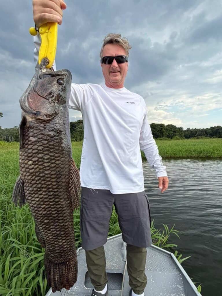 Guest holding a fish caught in the river