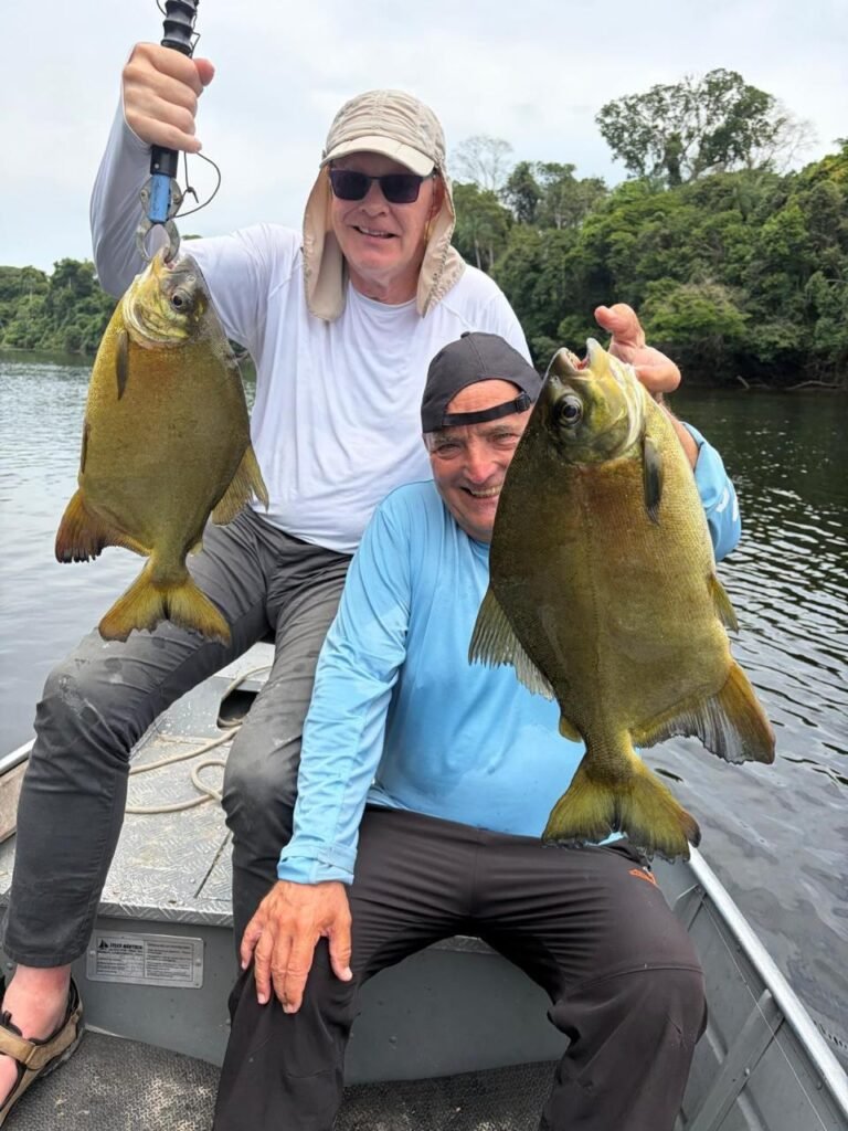 Guest holding a fish caught in the river