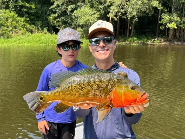Guest holding a fish caught in the river